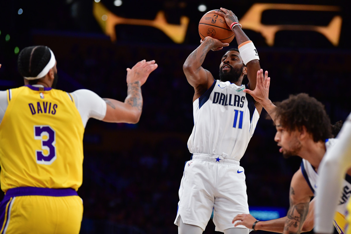 Mavs' Kyrie Irving shoots a jumpshot over Lakers' Anthony Davis.